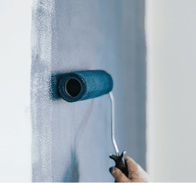 Paint roller applying paint to a wall