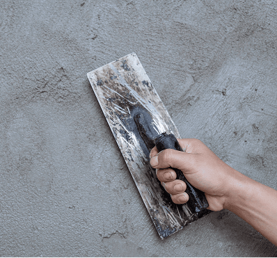 Trowel smoothing a stucco surface